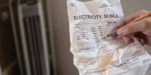 Electricity bill, radiator, hand, pen